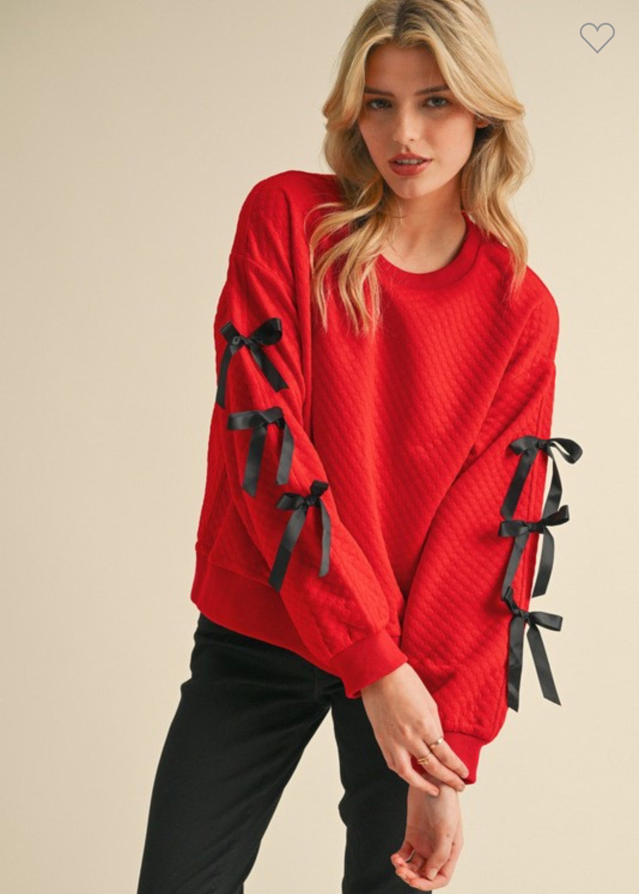 Embossed textured red top with black bows marked down