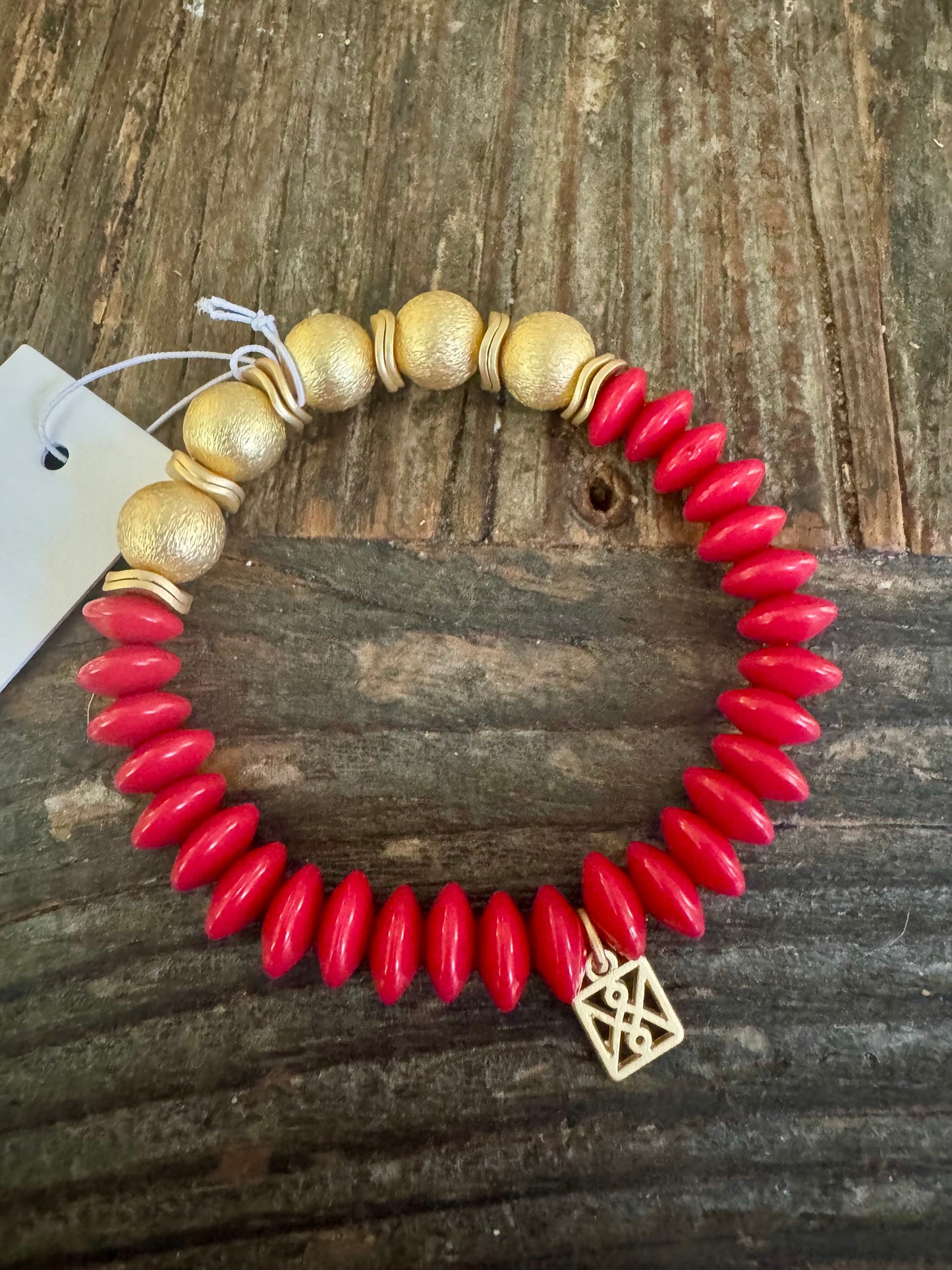 Red bracelet with gold beads