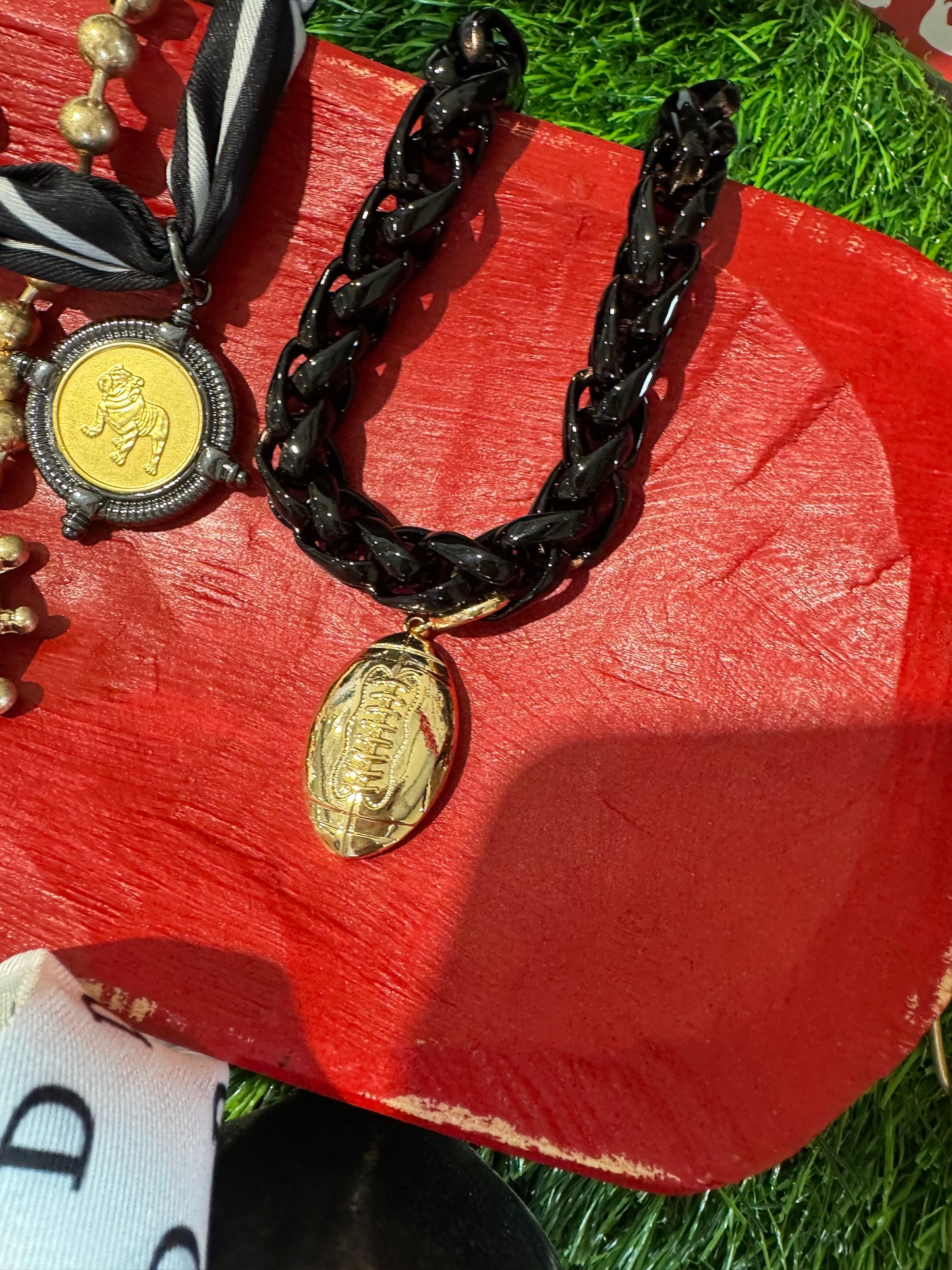 Black chain necklace with gold football charm