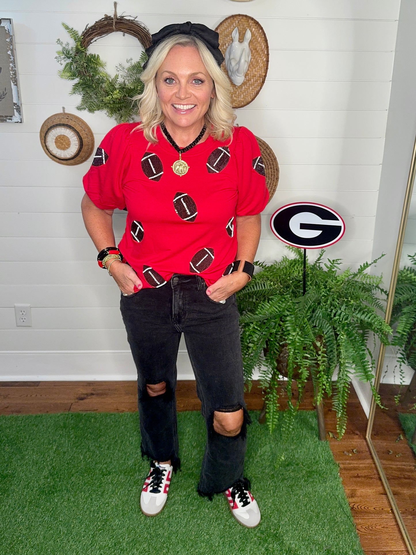 New red boutique top with sparkle footballs and bubble sleeves