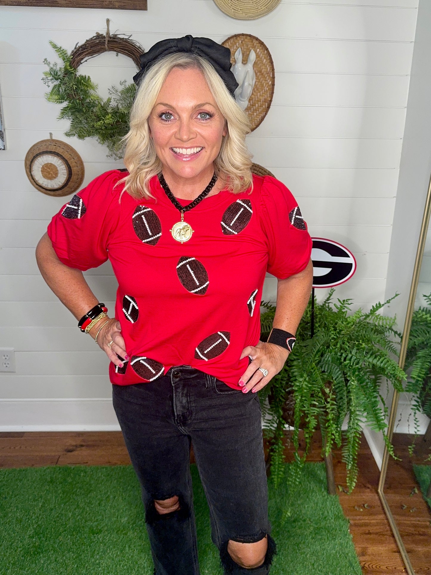 New red boutique top with sparkle footballs and bubble sleeves