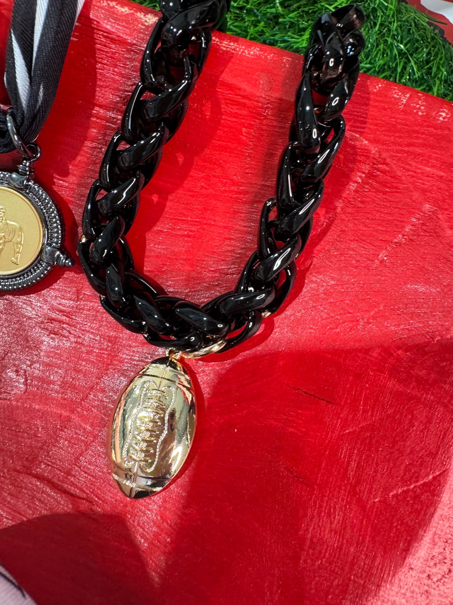 Black chain necklace with gold football charm