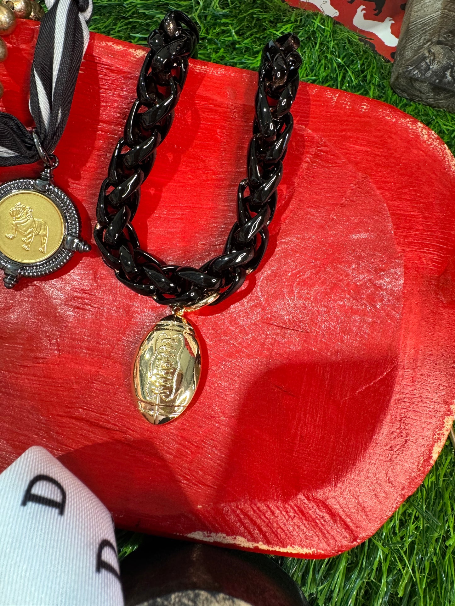 Black chain necklace with gold football charm