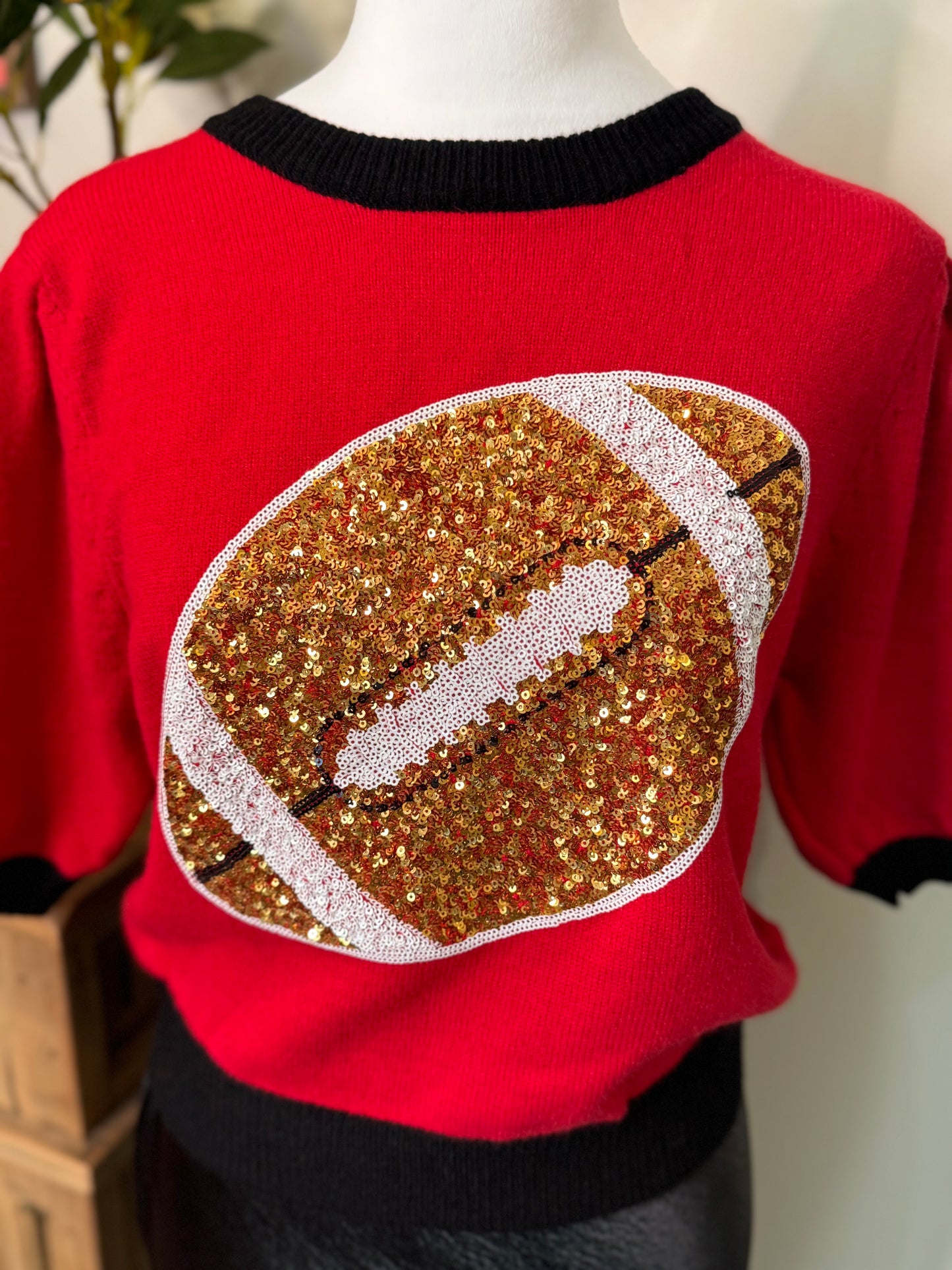 Red and black sweater sequin football