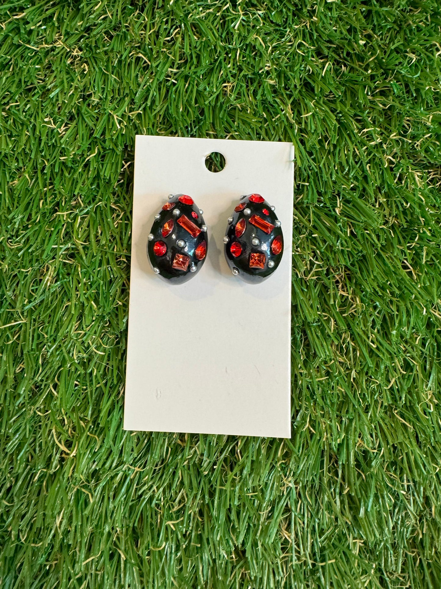 Black resin tear drop earrings with red stones