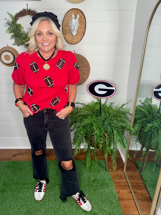 New red boutique top with sparkle footballs and bubble sleeves