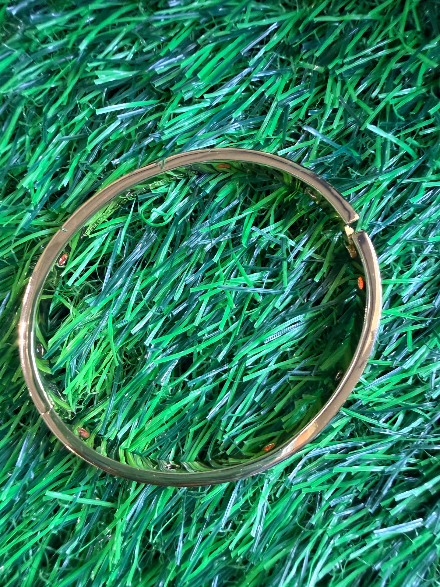 Gold bangle with black and red
