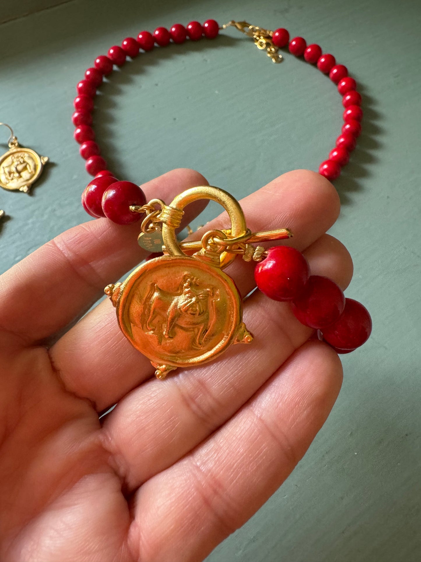 Gold dog medallion bracelet red coral Susan Shaw