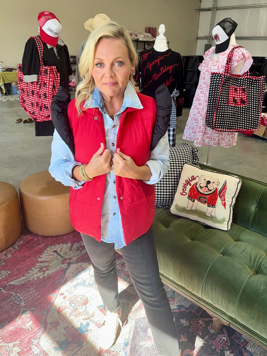 red puffer vest with black ruffle sleeves