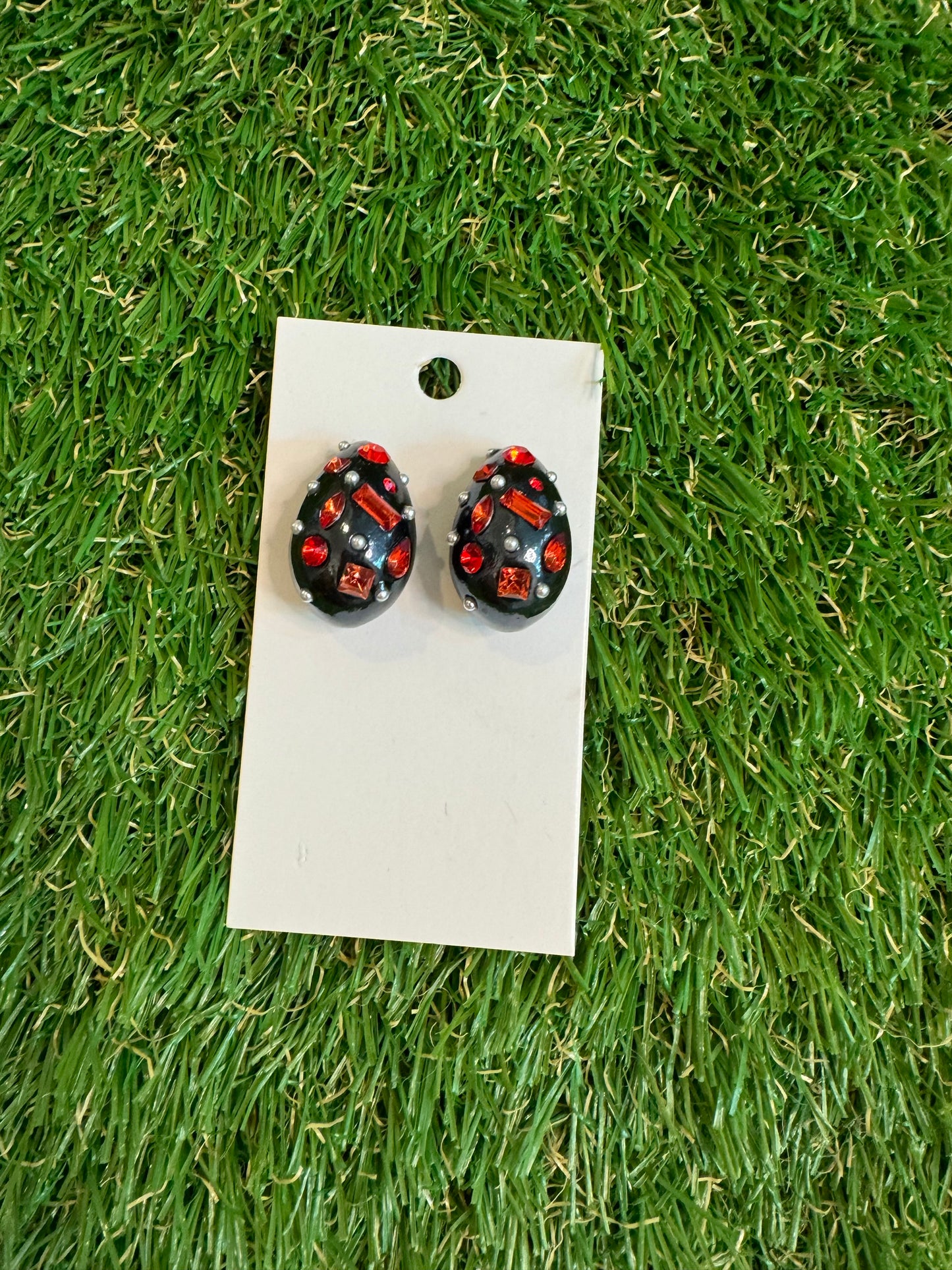 Black resin tear drop earrings with red stones