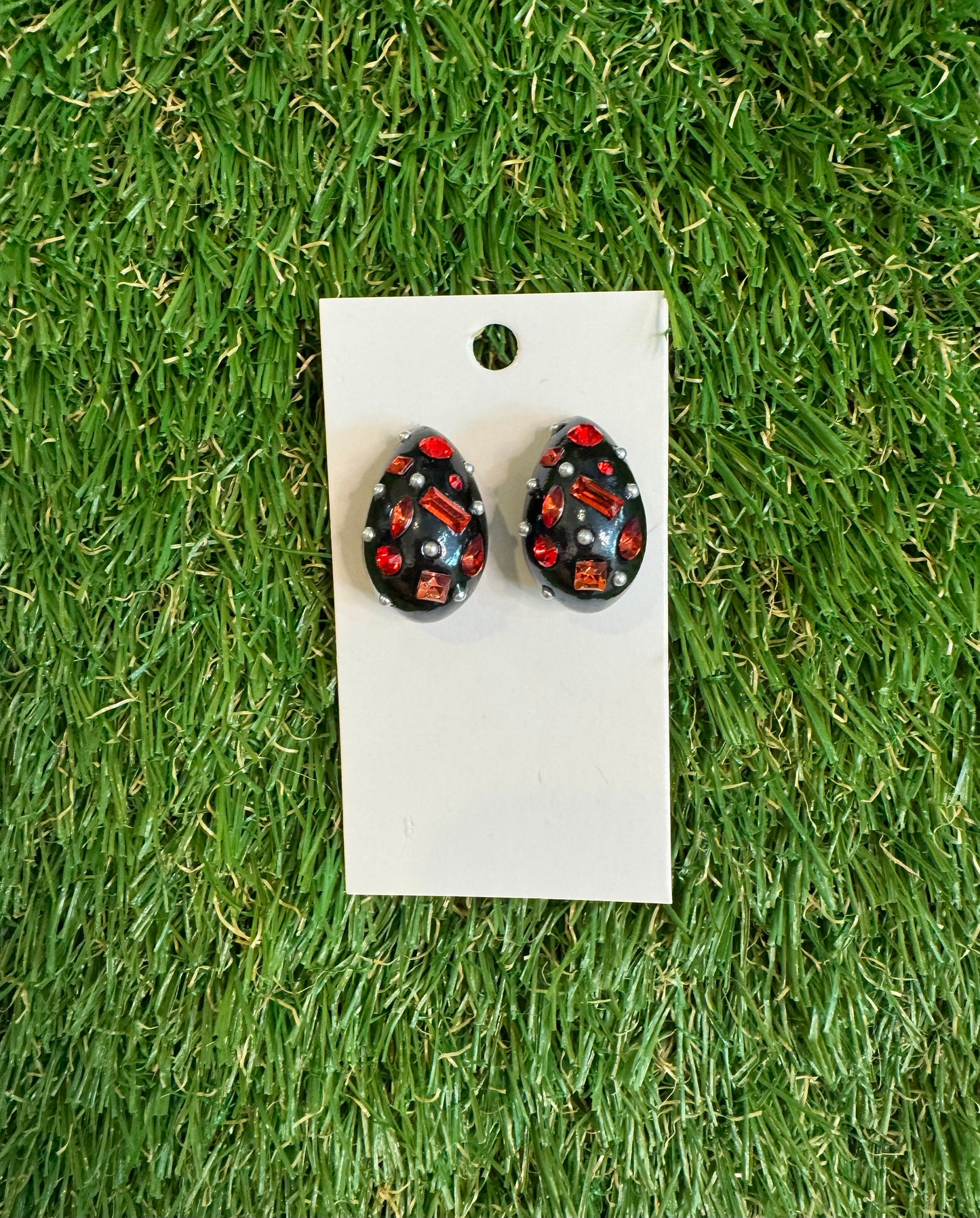 Black resin tear drop earrings with red stones