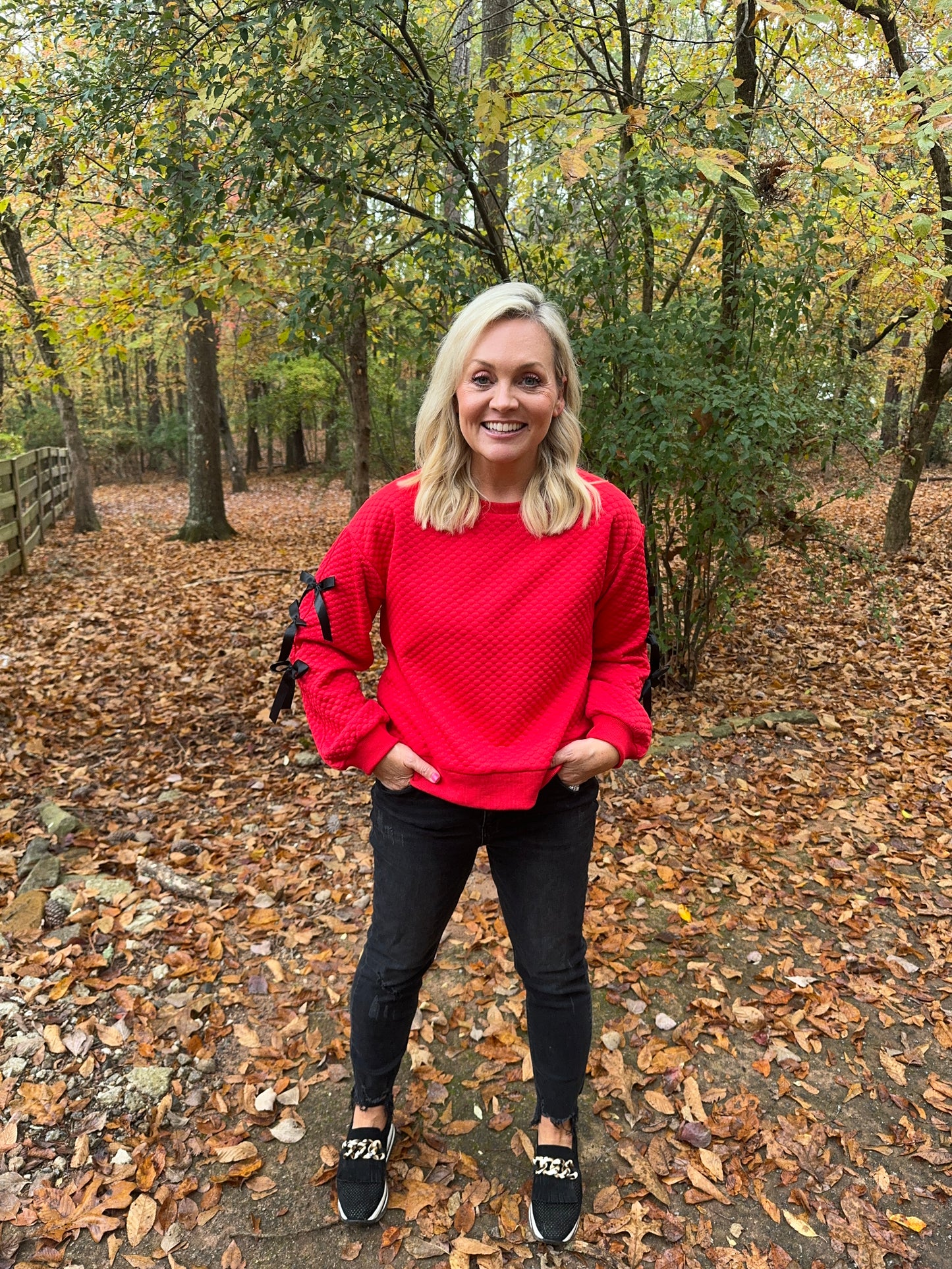 Embossed textured red top with black bows