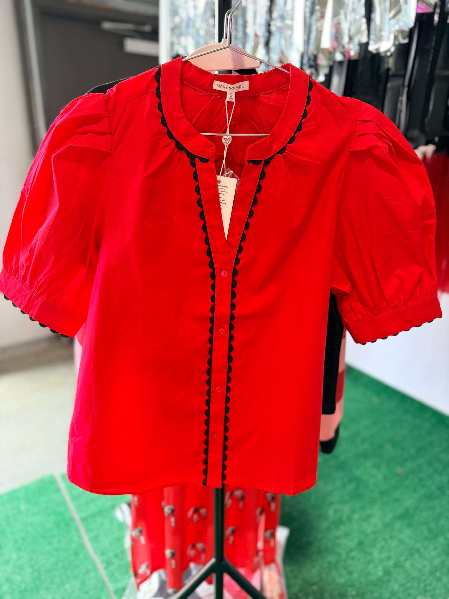 Red blouse with black pipping