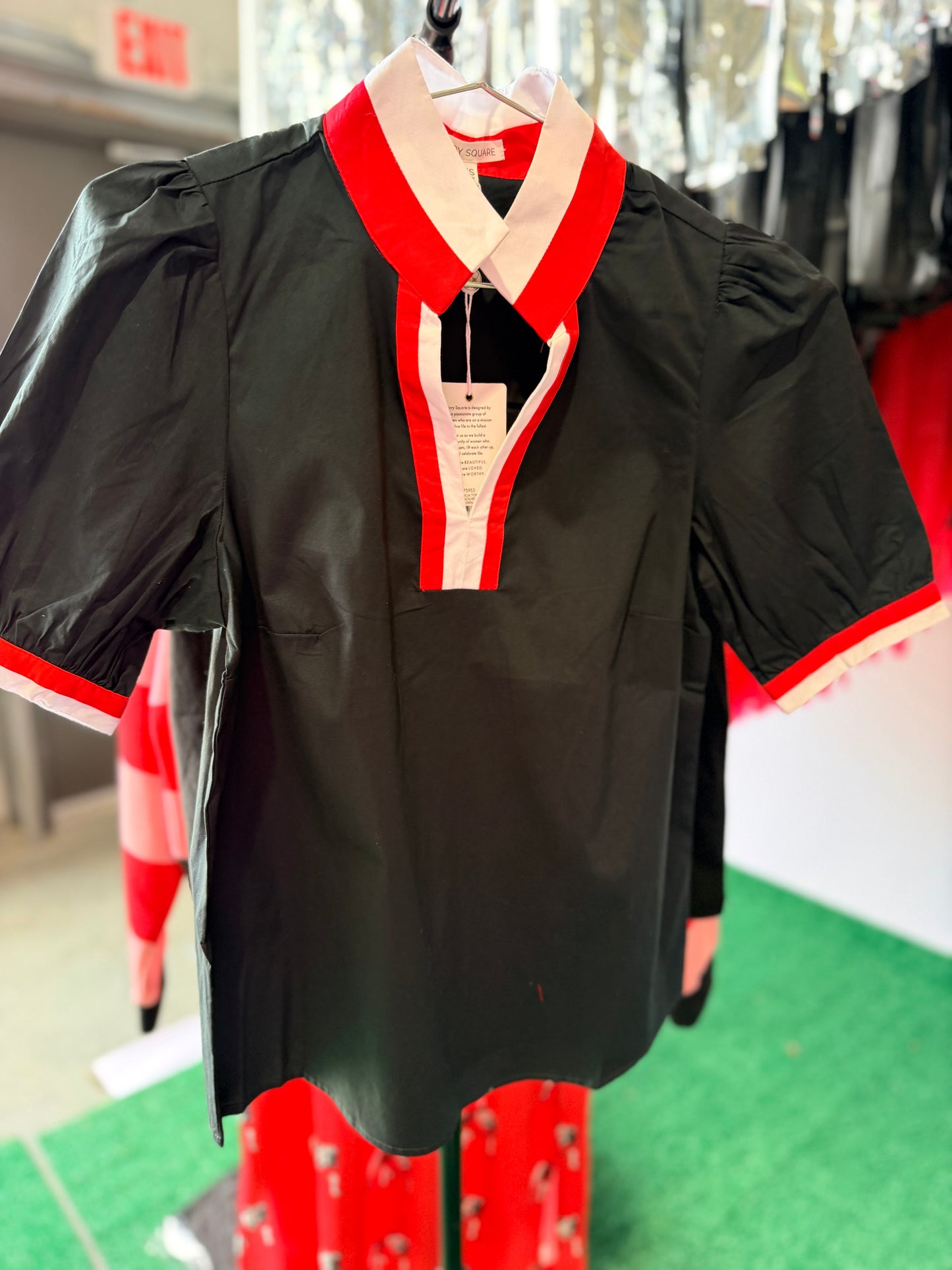 Black blouse with red and white trim