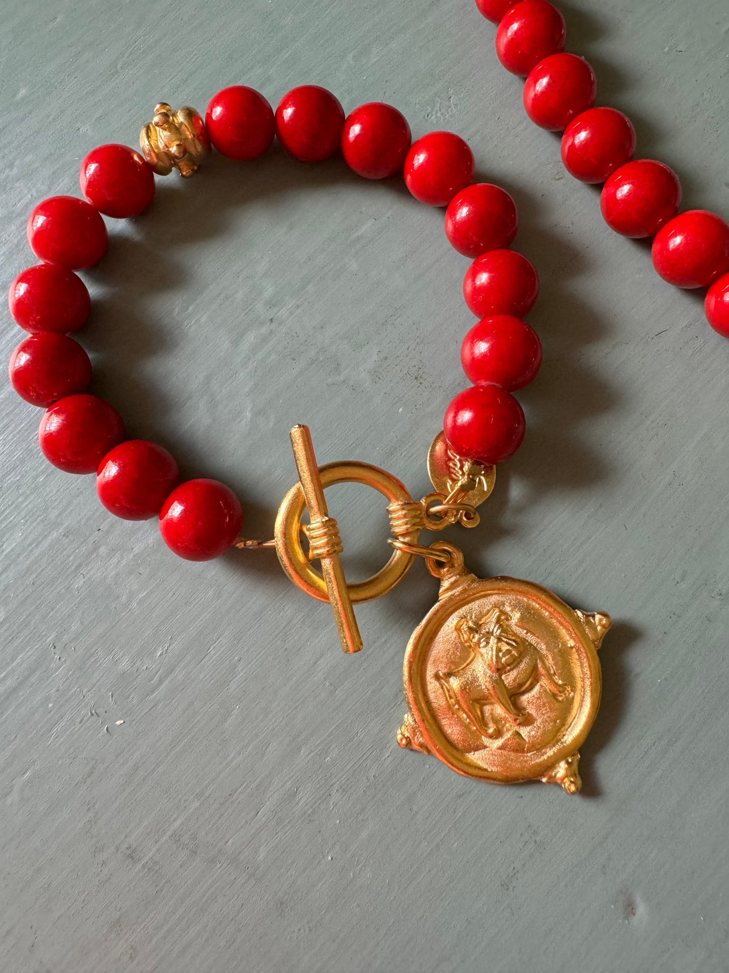 Gold dog medallion bracelet red coral Susan Shaw