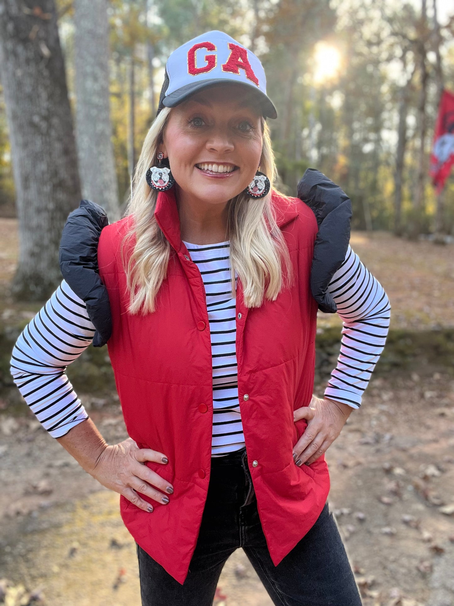 red puffer vest with black ruffle sleeves