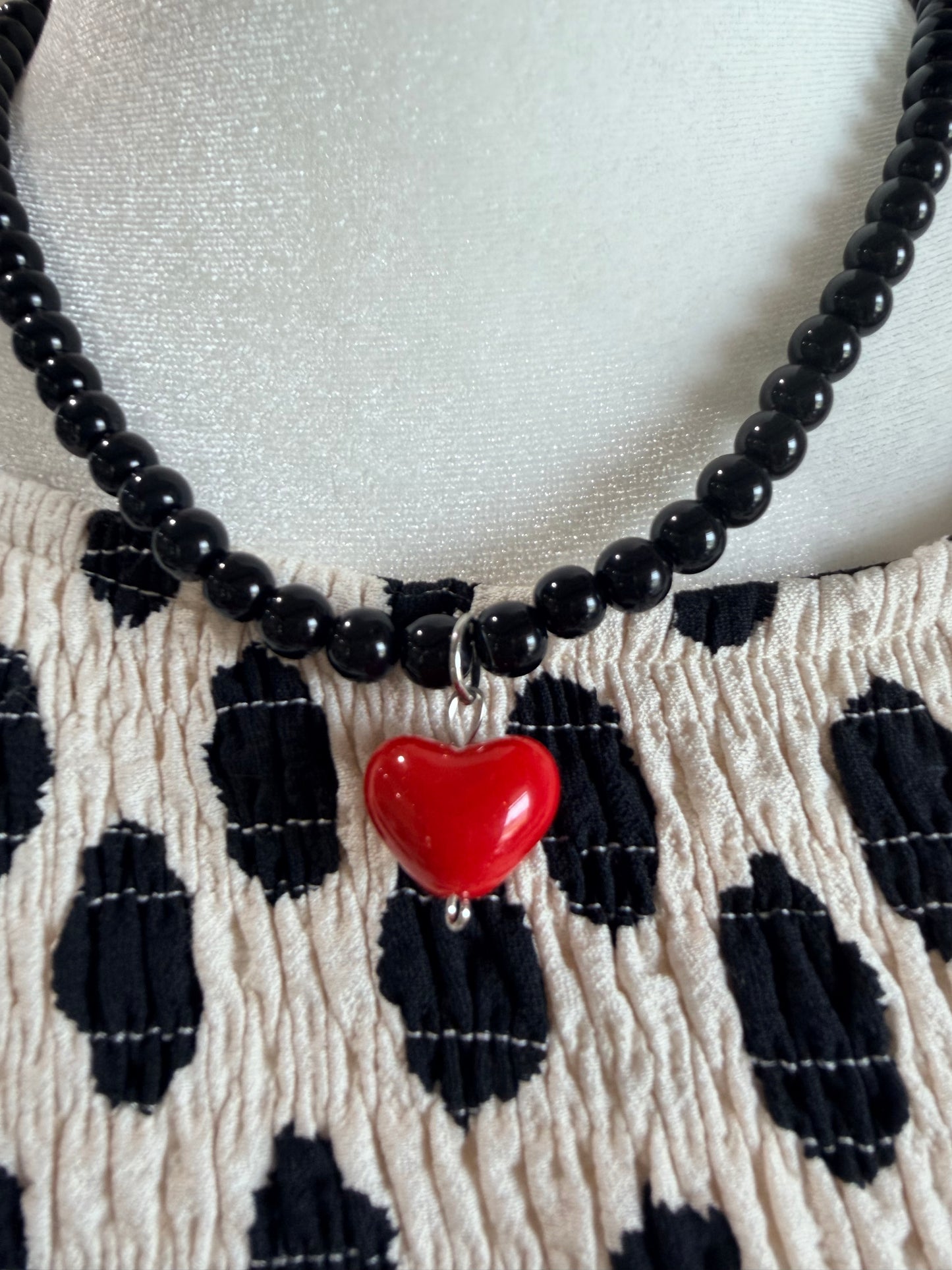 Black beaded necklace with red heart