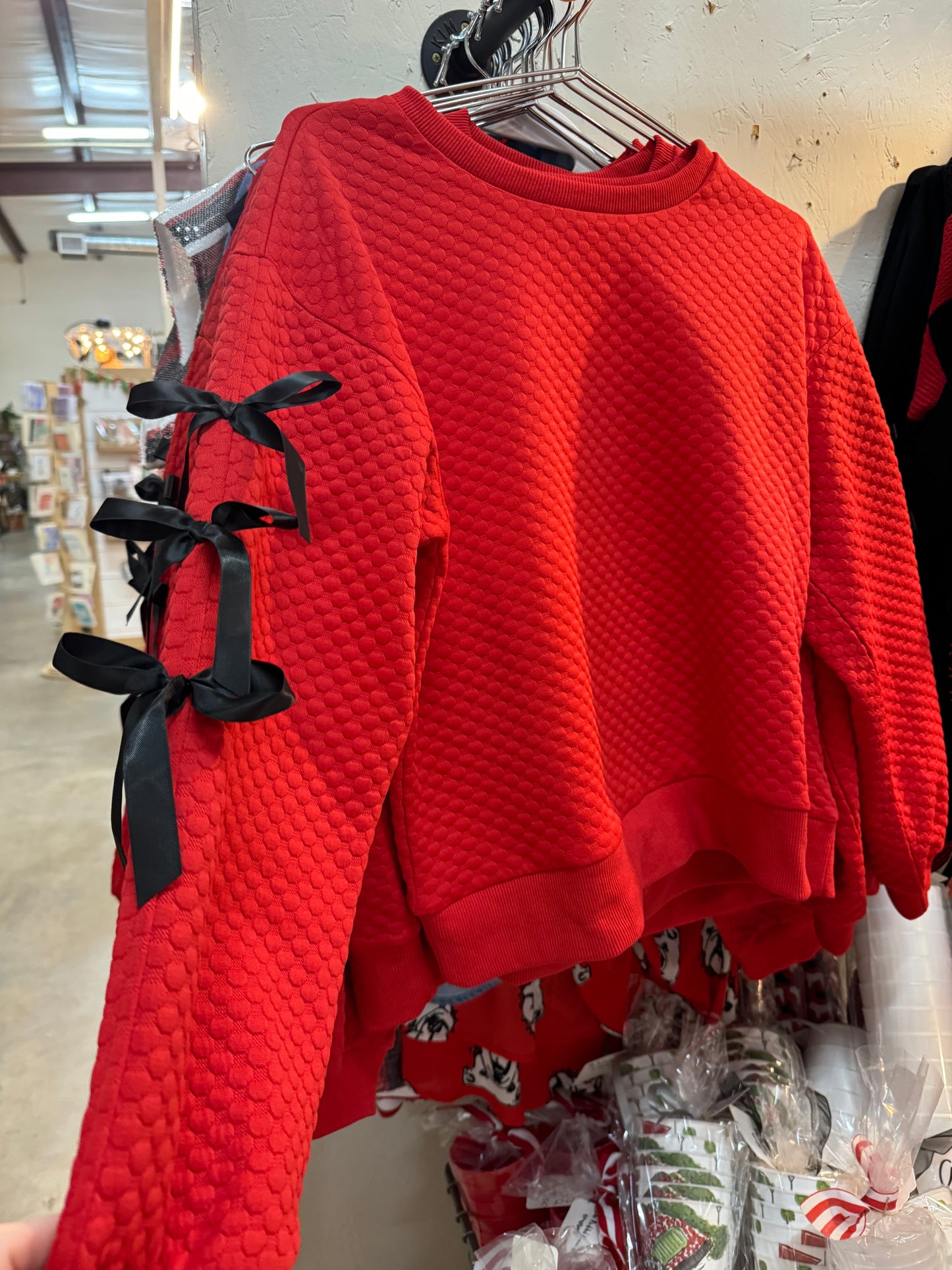 Embossed textured red top with black bows